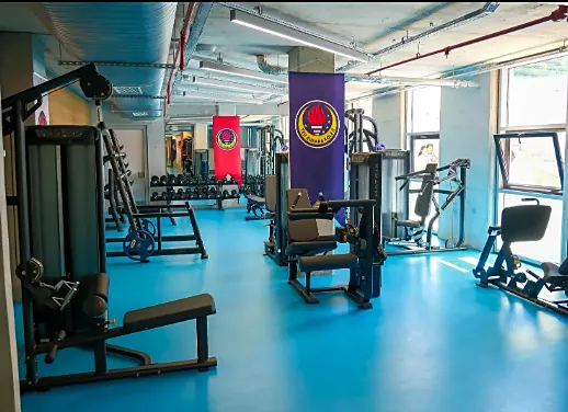 TED Ankara Koleji fitness salonu, tamamlanmış hali: kuvvet aletleri ve mavi spor zemini